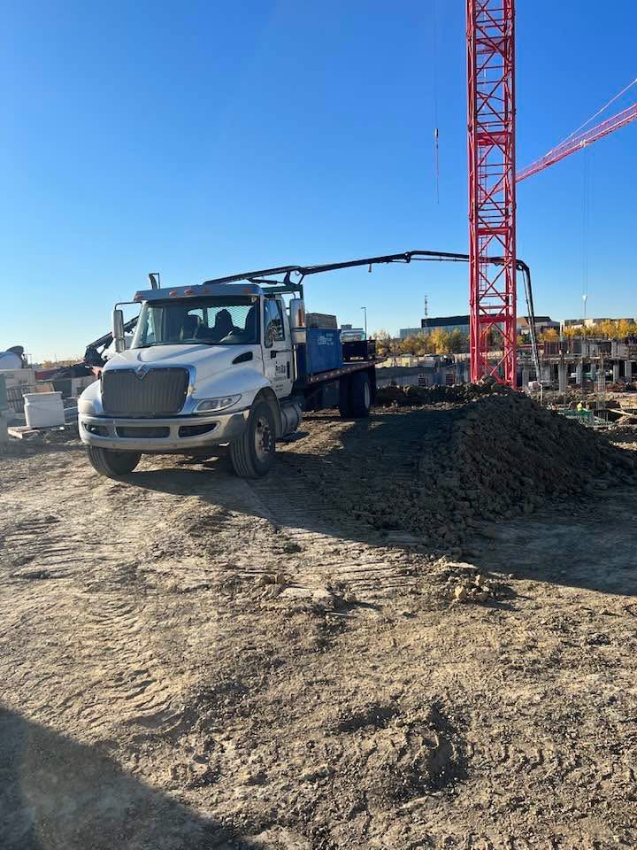 Construction site delivery with heavy equipment and crane